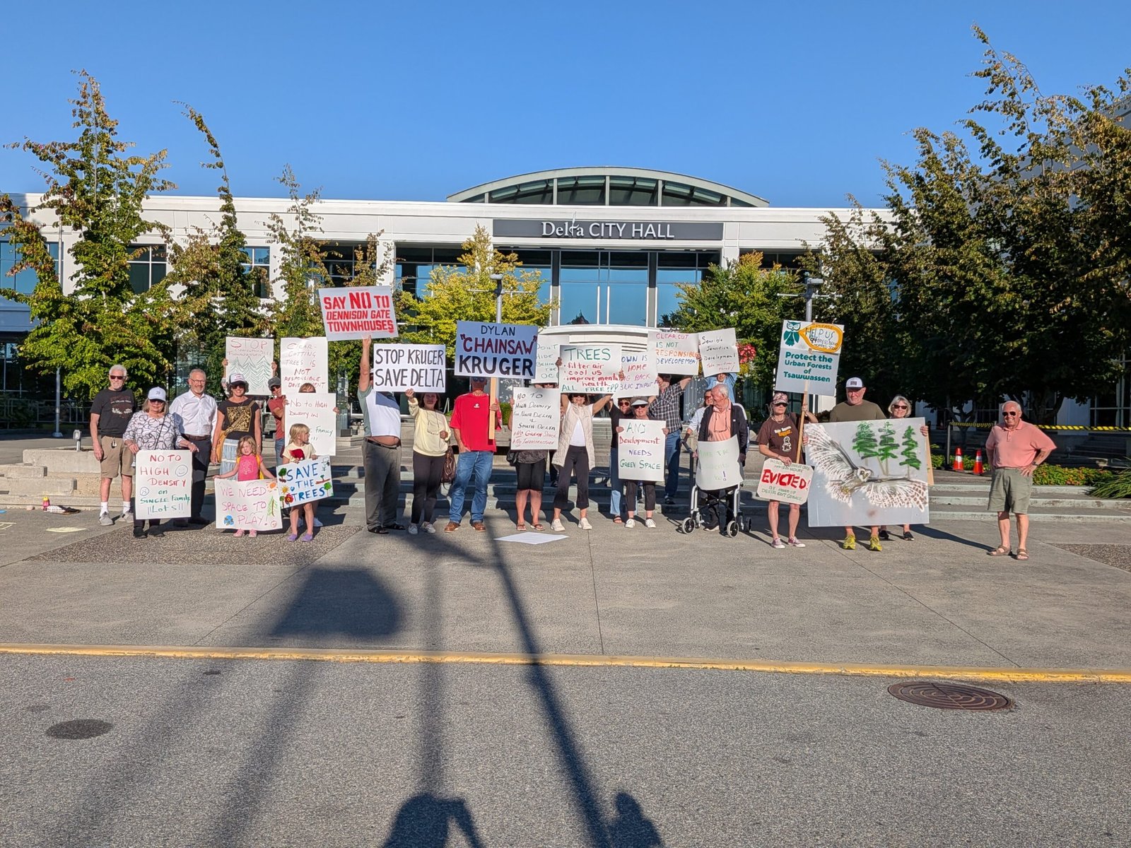 Residents holding signs outside Delta City Hall